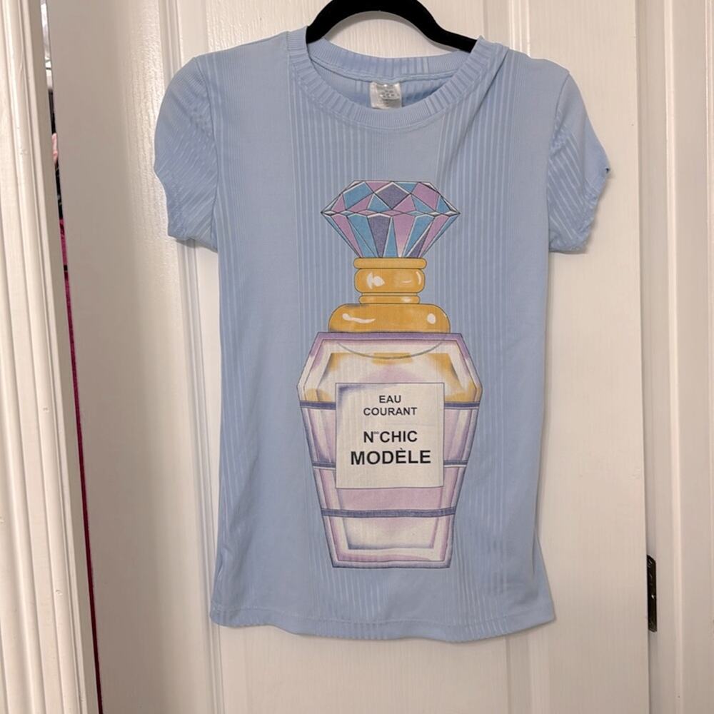 Cleek girl baby blue top with perfume logo. Size M